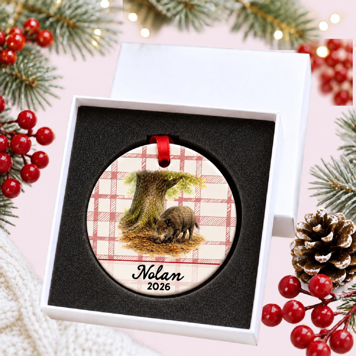 Personalized wild boar ceramic ornament with name and year on red plaid in a white gift box with protective foam