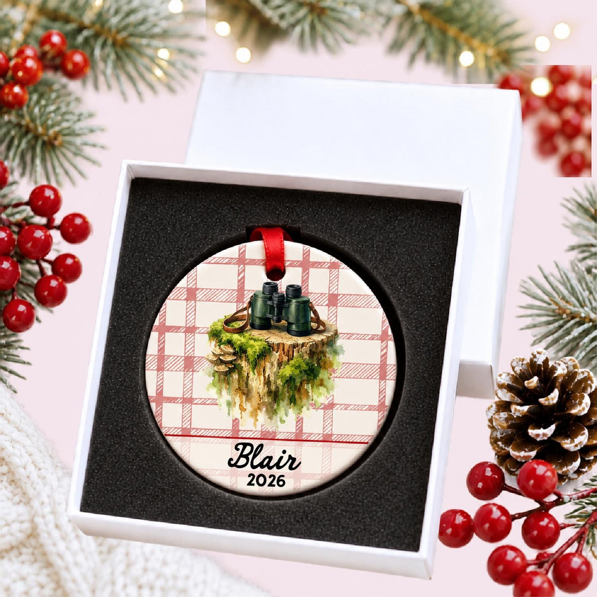 Personalized binoculars ceramic ornament with name and year on red plaid in a white gift box with protective foam
