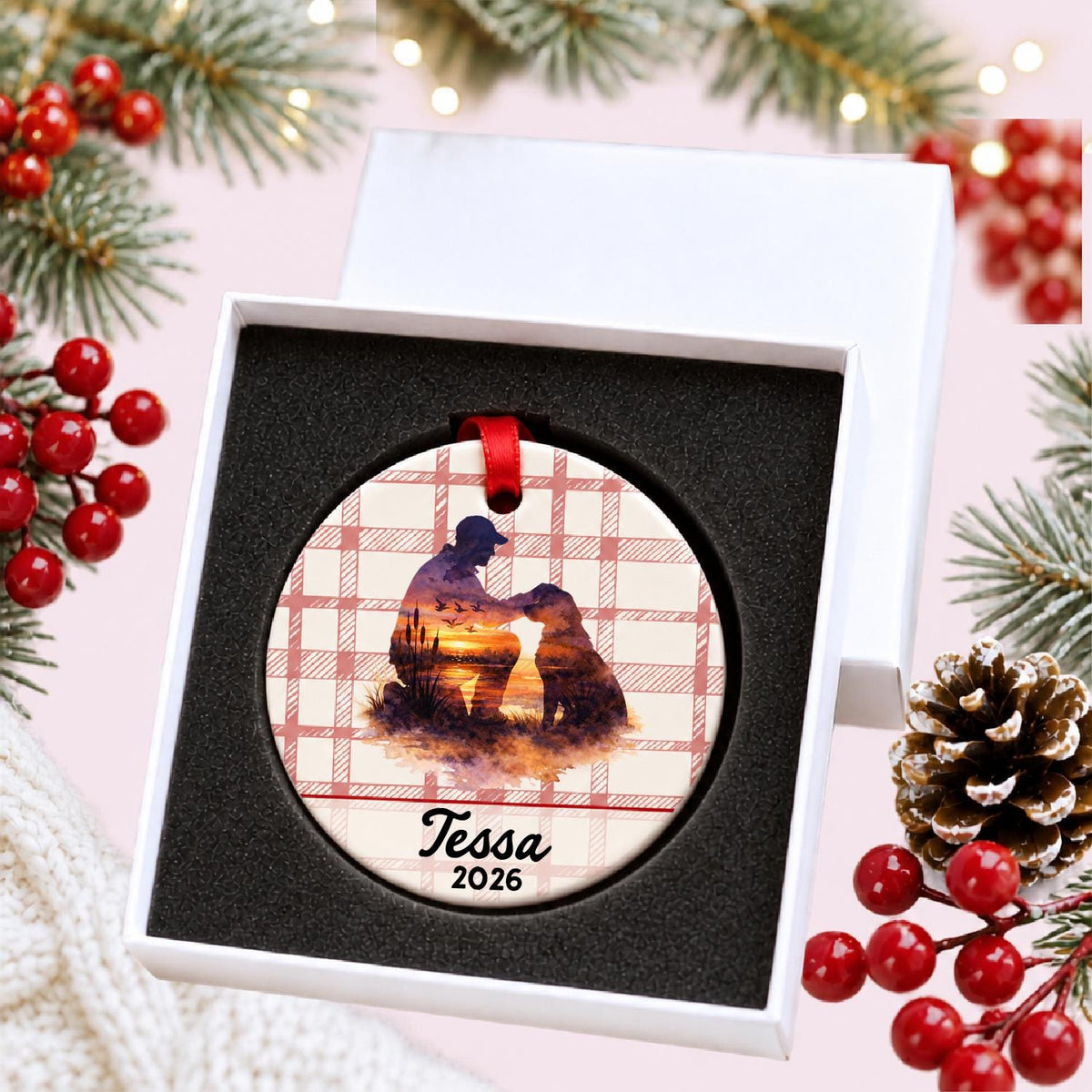 Personalized hunter and dog ceramic ornament with name and year on red plaid in a white gift box with protective foam