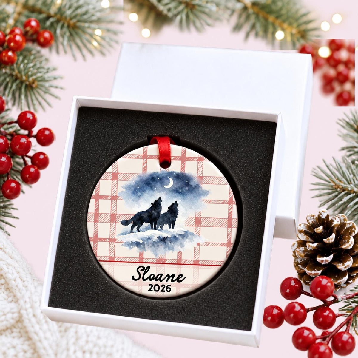 Personalized howling wolf pair ceramic ornament with name and year on red plaid in a white gift box with protective foam