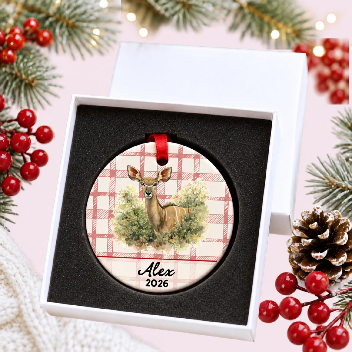 Personalized kudu in woodland ceramic ornament with name and year on red plaid in a white gift box with protective foam