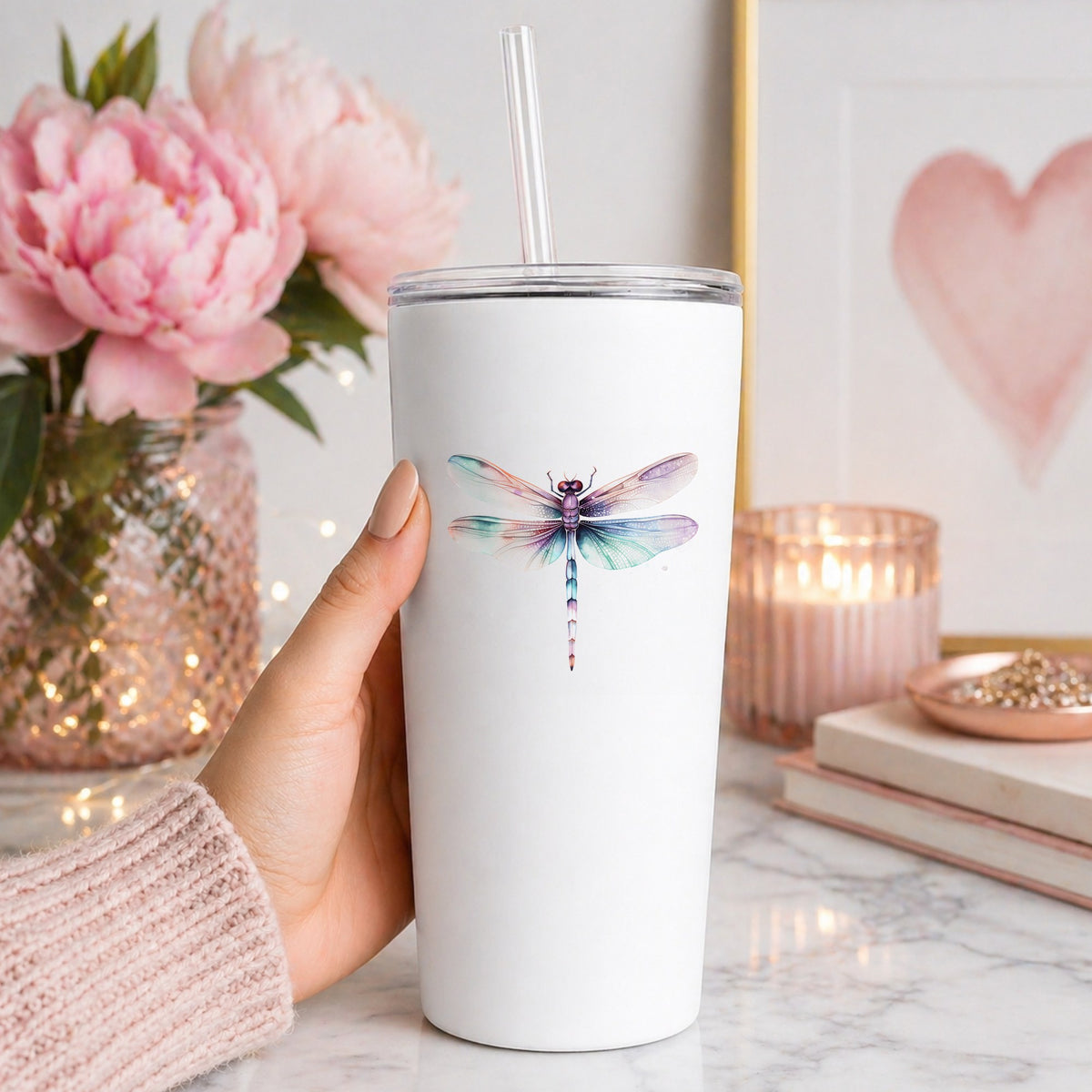 Pastel watercolor dragonfly decal on a white tumbler in a home setting