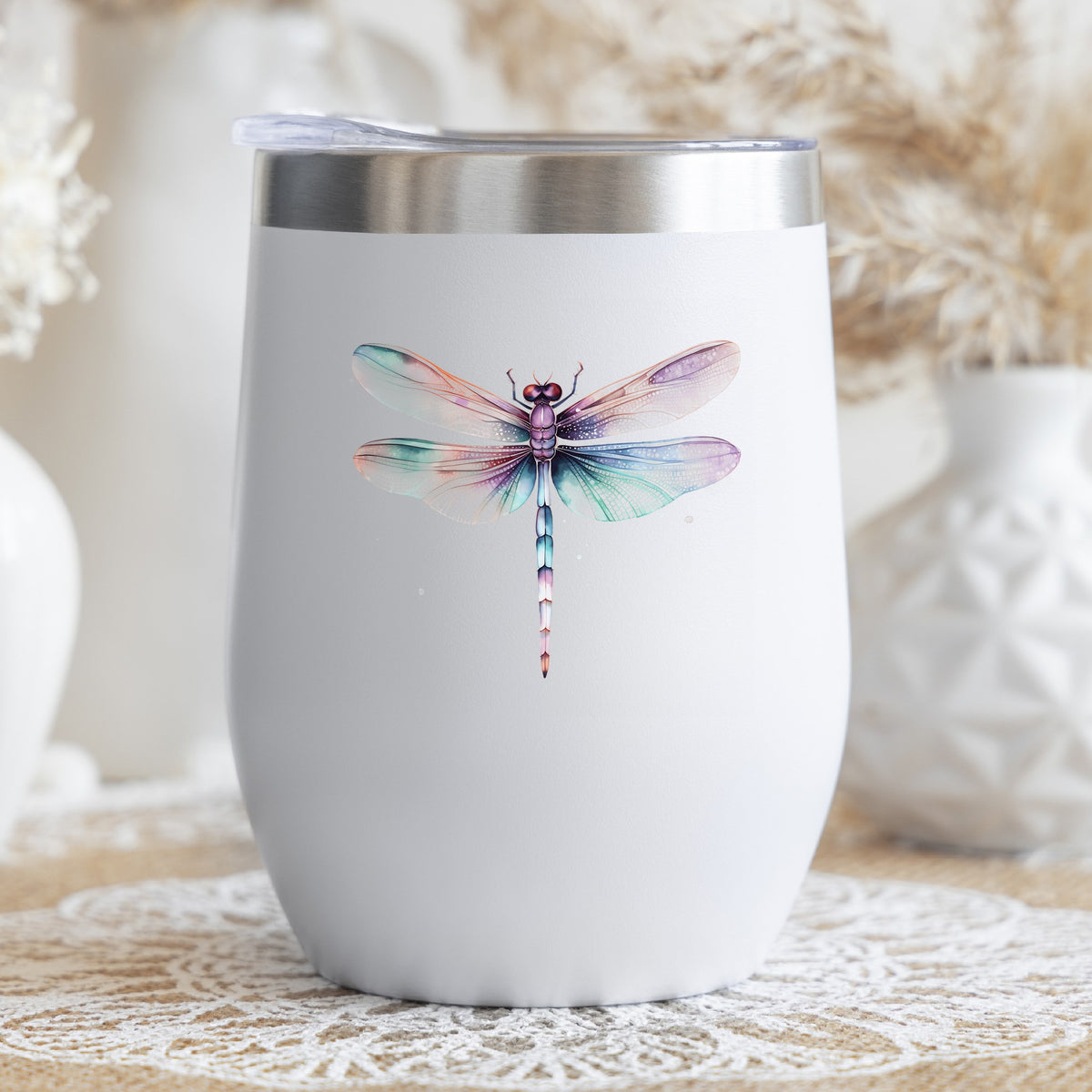 Pastel watercolor dragonfly UV DTF decal on a stemless wine glass