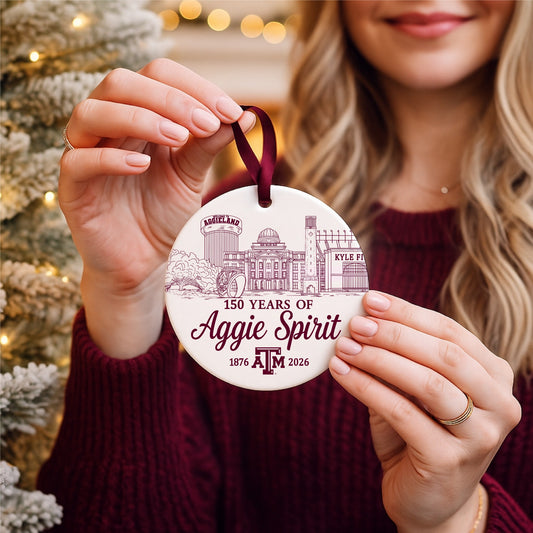 Texas A&M 150 Years of Aggie Spirit ceramic ornament held in front of a Christmas tree