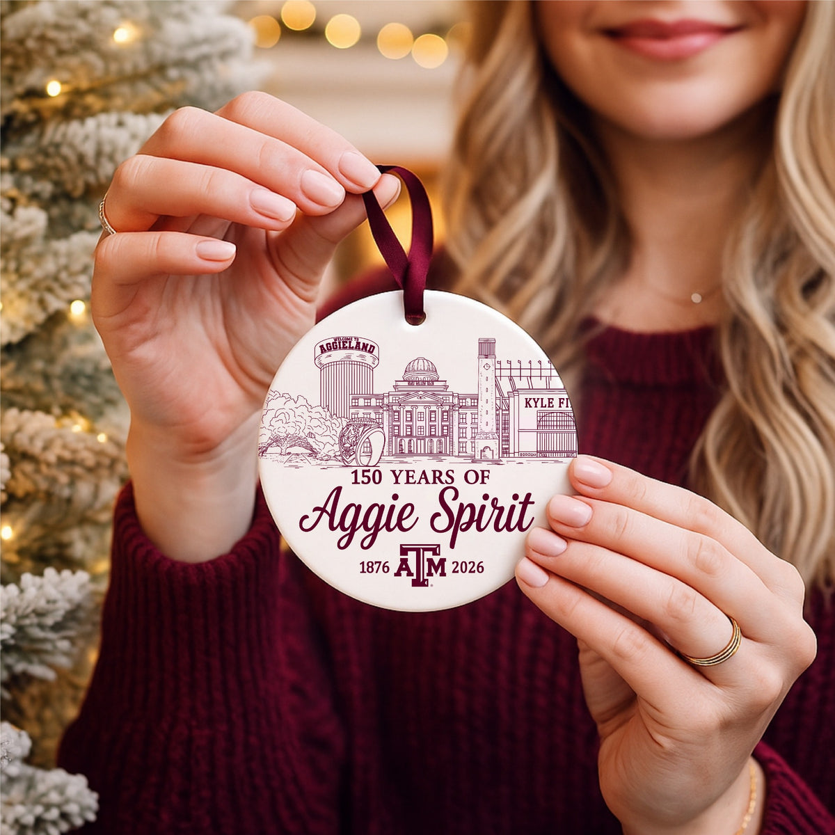 Texas A&M 150 Years of Aggie Spirit ceramic ornament held in front of a Christmas tree