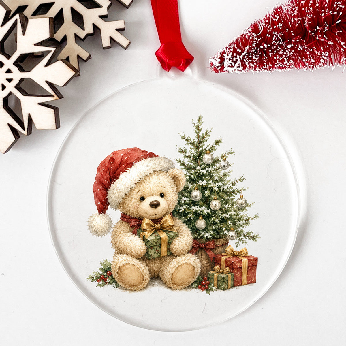 Christmas teddy bear UV DTF sticker applied to a clear acrylic ornament