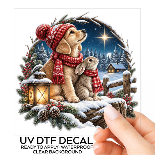 Christmas Puppy And Bunny In Snow UV DTF sticker on its backing card, held in hand