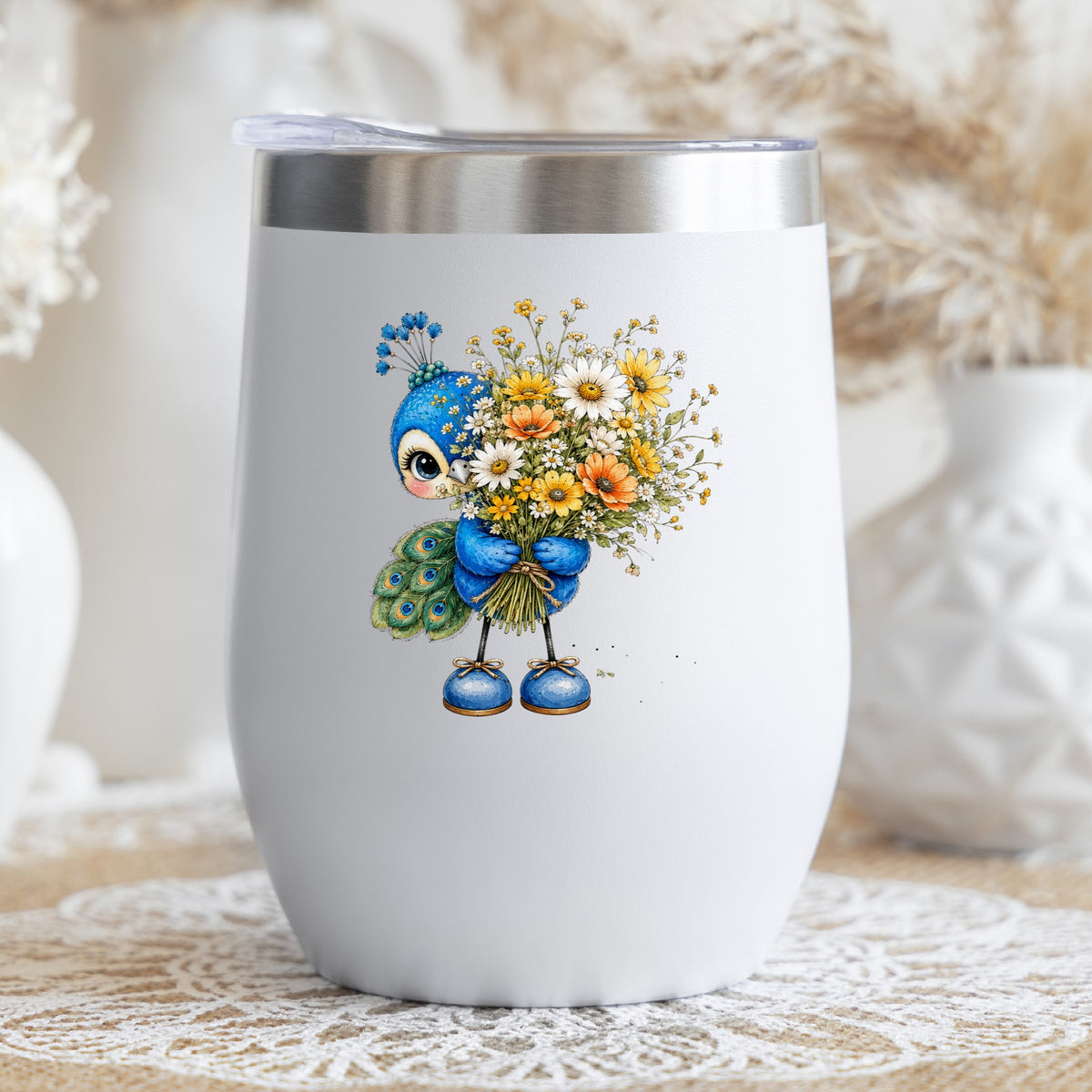 Peacock Holding Wildflower Bouquet UV DTF sticker applied to a white stemless tumbler with a lid