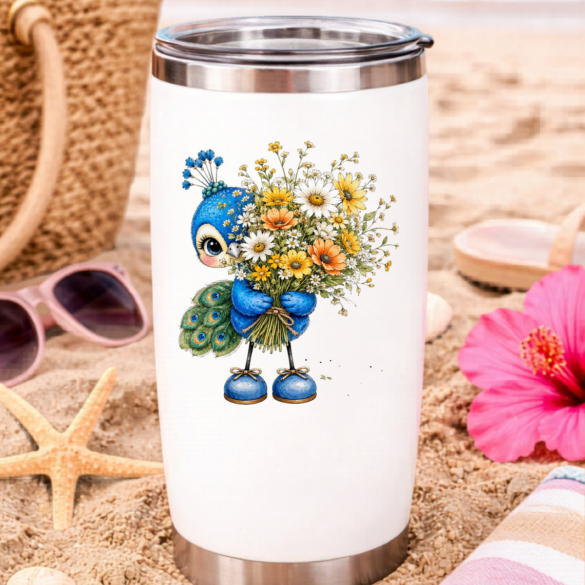 Peacock Holding Wildflower Bouquet UV DTF sticker applied to a white travel tumbler on beach sand