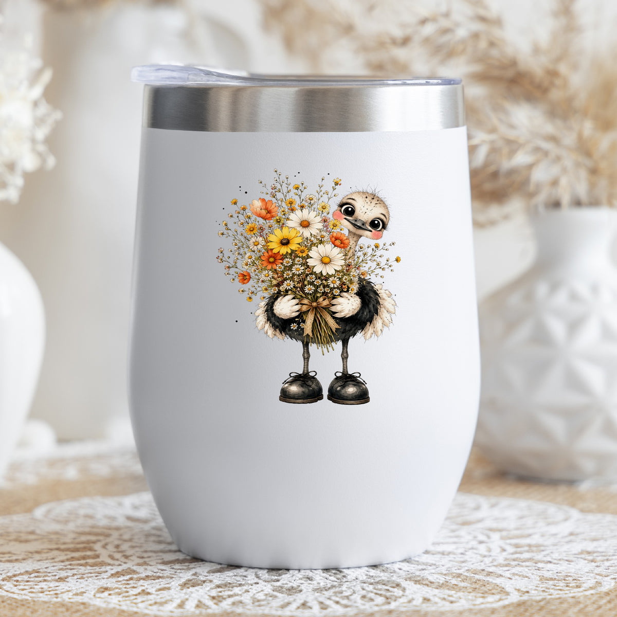 Ostrich Holding Daisy Bouquet UV DTF sticker applied to a white stemless tumbler with a lid