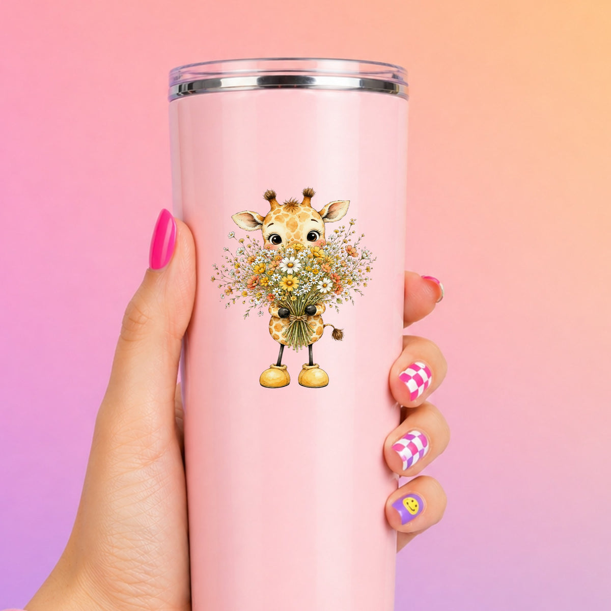 Baby Giraffe Holding Wildflower Bouquet UV DTF sticker applied to a tall pink tumbler on a pink and orange background