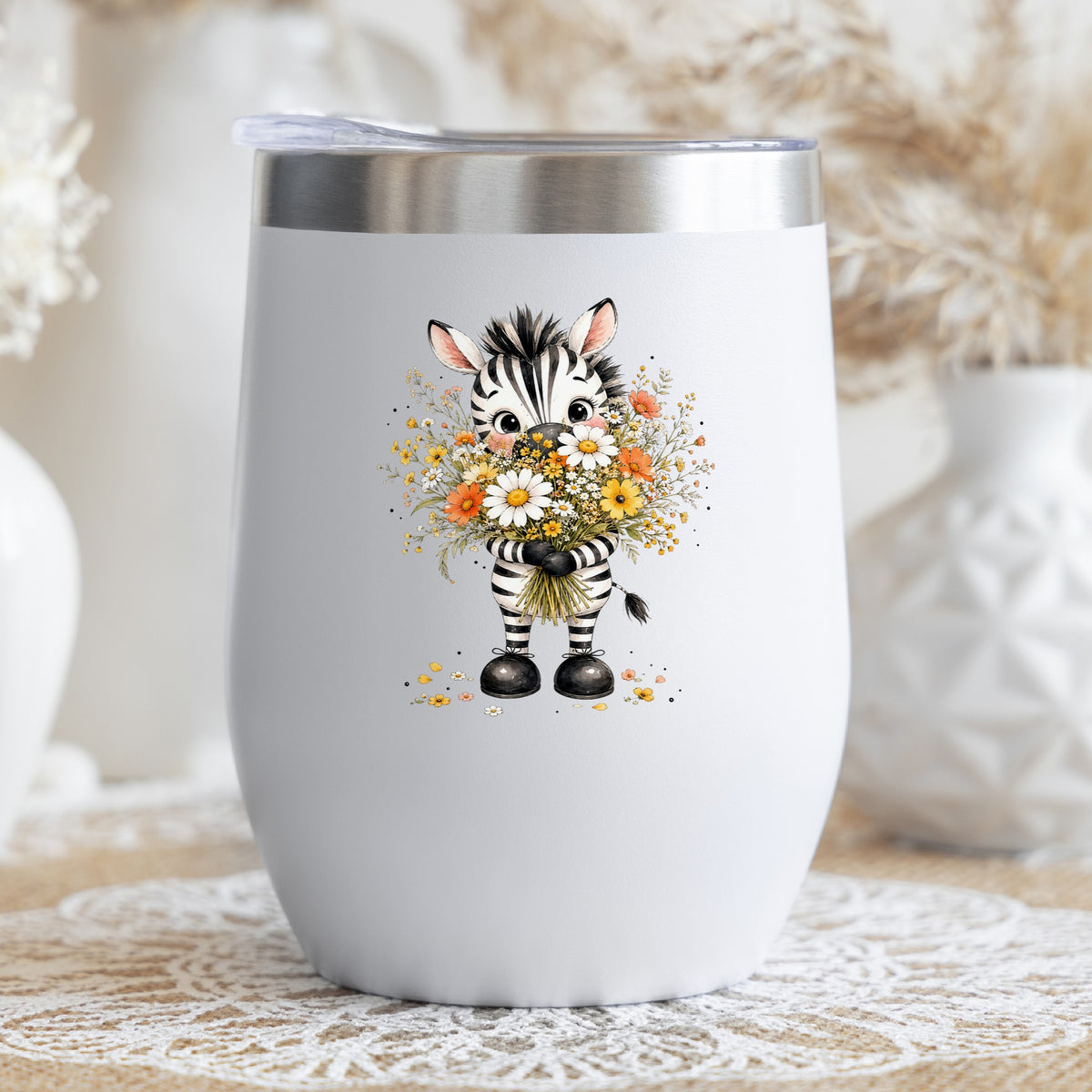 Zebra Holding Wildflower Bouquet UV DTF sticker applied to a white stemless tumbler with a lid