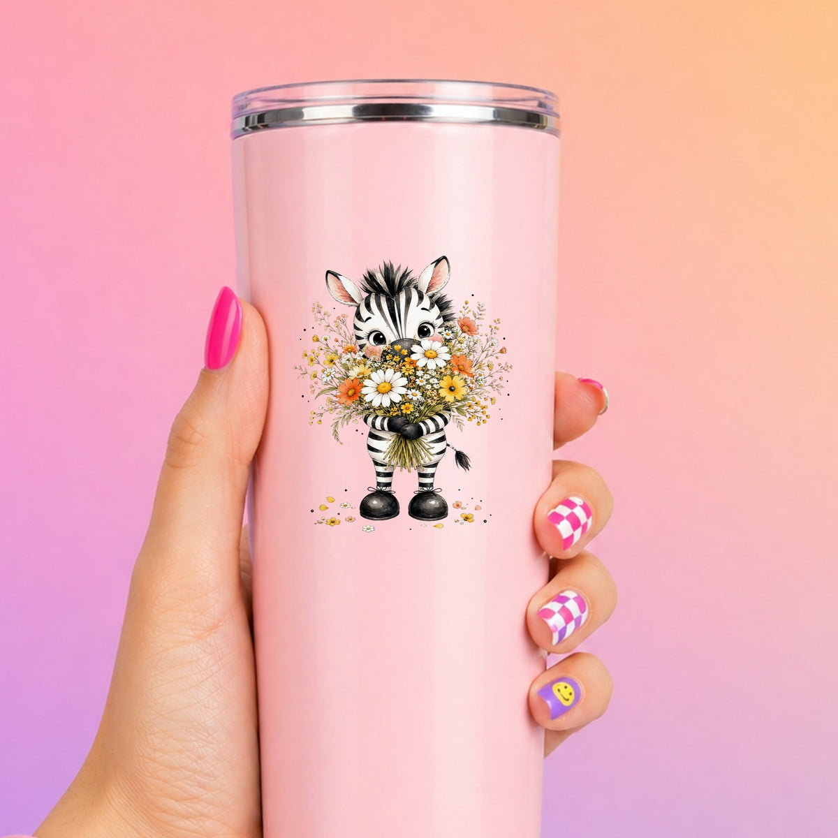 Zebra Holding Wildflower Bouquet UV DTF sticker applied to a tall pink tumbler on a pink and orange background