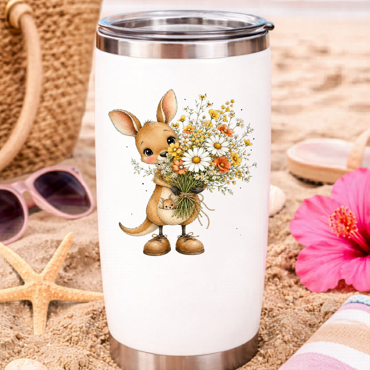 Kangaroo Holding Daisy Bouquet UV DTF sticker applied to a white travel tumbler on beach sand