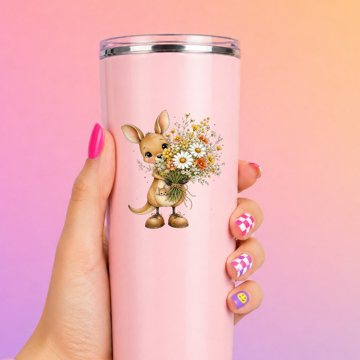 Kangaroo Holding Daisy Bouquet UV DTF sticker applied to a tall pink tumbler on a pink and orange background