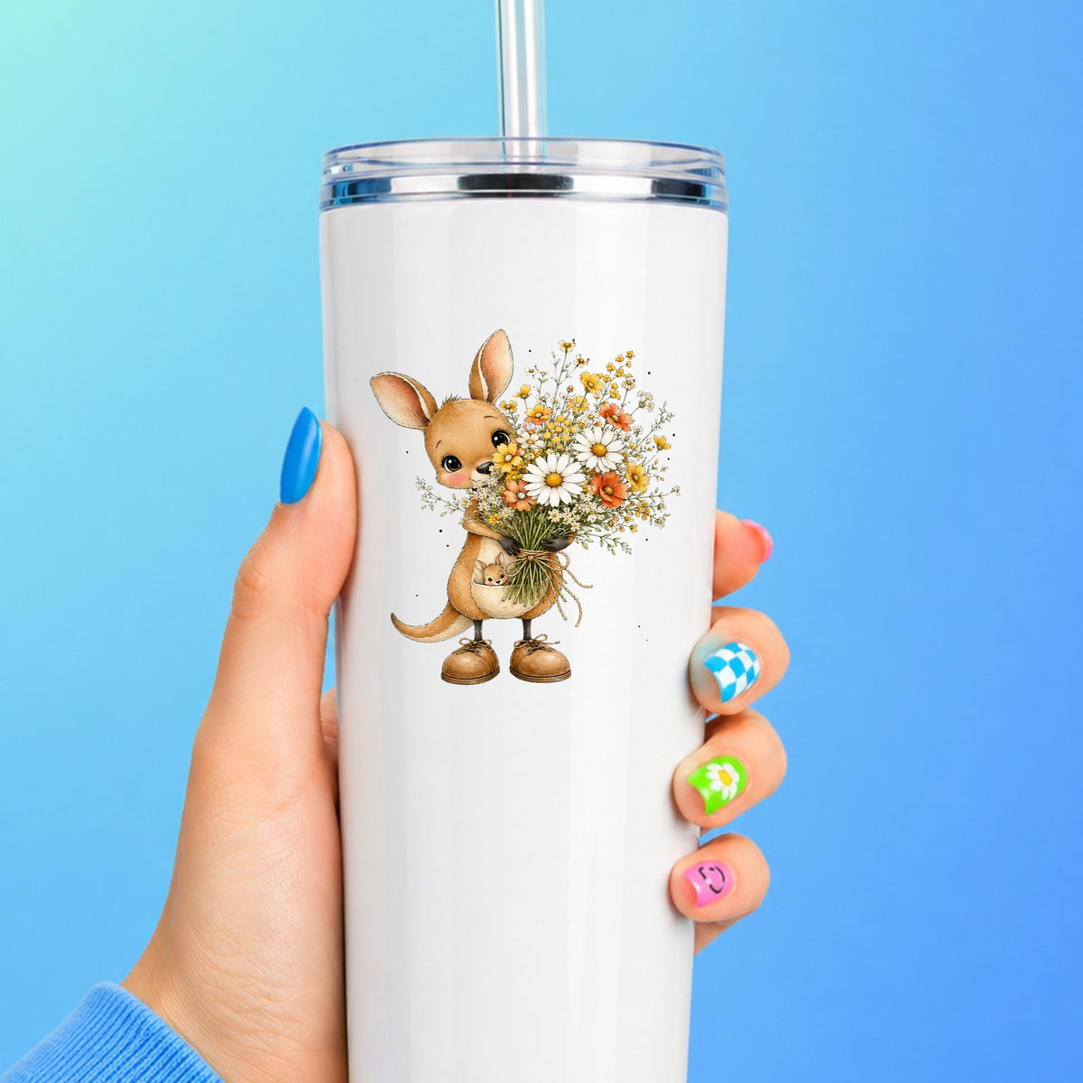 Kangaroo Holding Daisy Bouquet UV DTF sticker applied to a white straw tumbler on a blue background