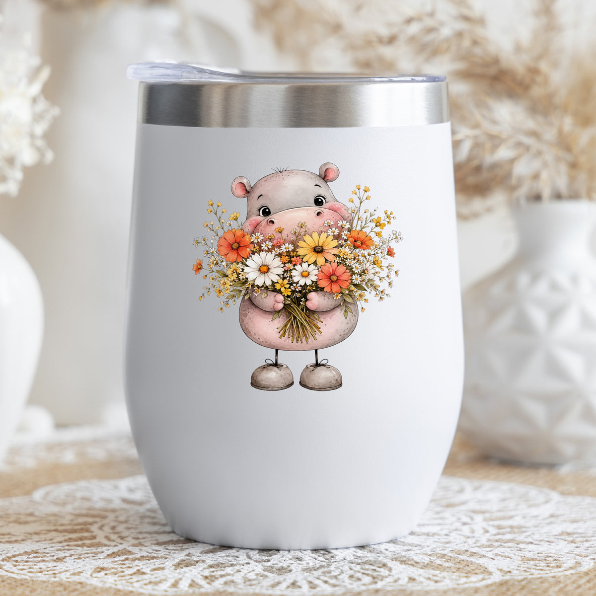 Pink Hippo Holding Wildflower Bouquet UV DTF sticker applied to a white stemless tumbler with a lid
