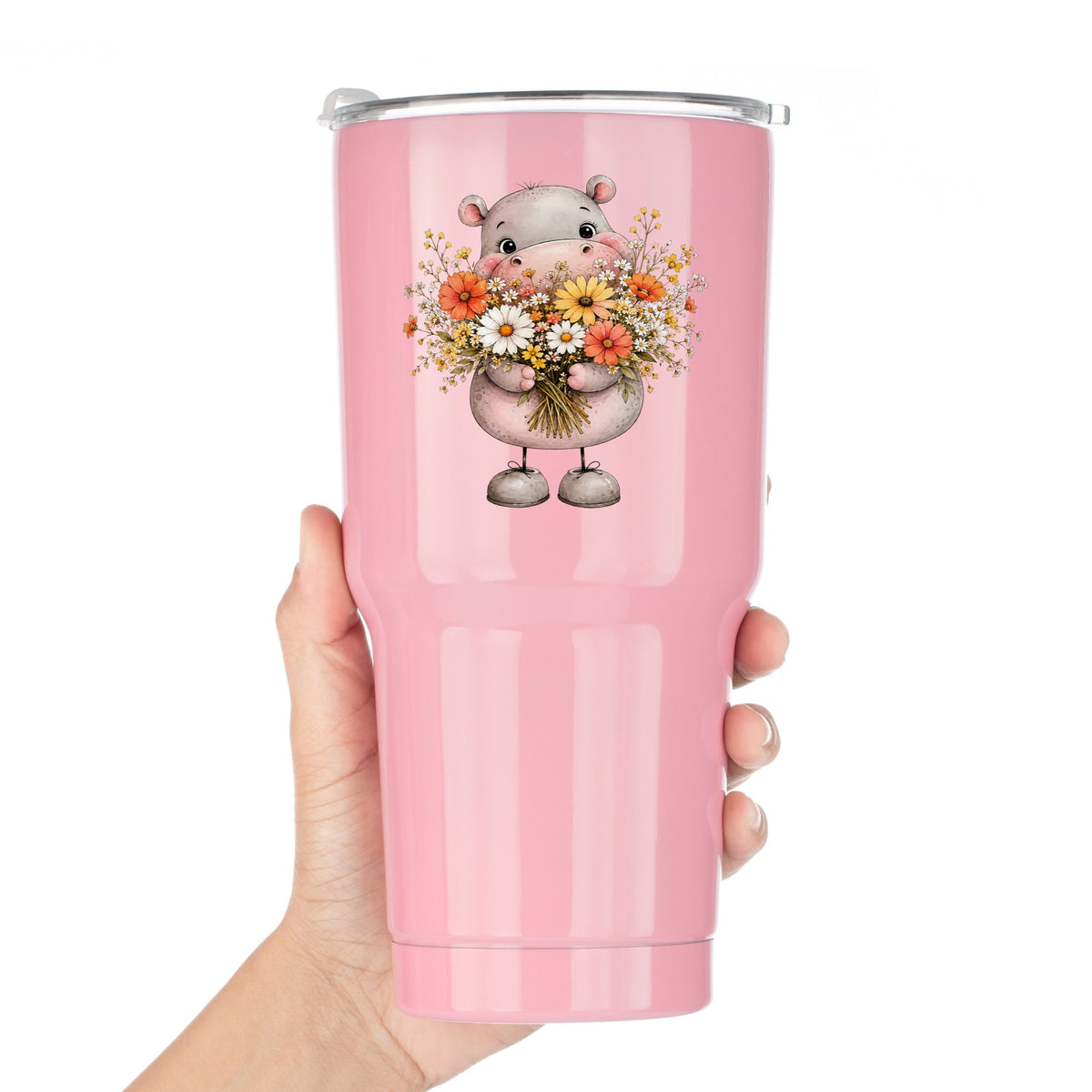 Pink Hippo Holding Wildflower Bouquet UV DTF sticker applied to a pink tumbler held against a white background