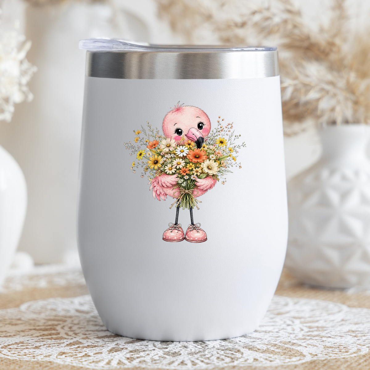 Pink Flamingo Holding Flower Bouquet UV DTF sticker applied to a white stemless tumbler with a lid