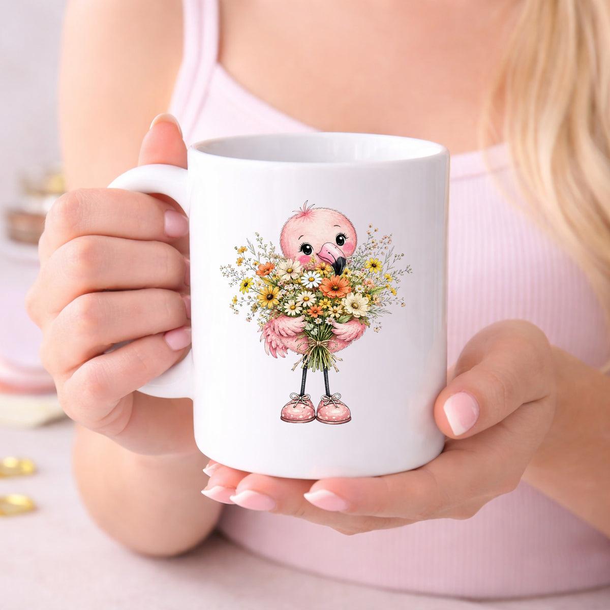 Pink Flamingo Holding Flower Bouquet UV DTF sticker applied to a white coffee mug held in both hands