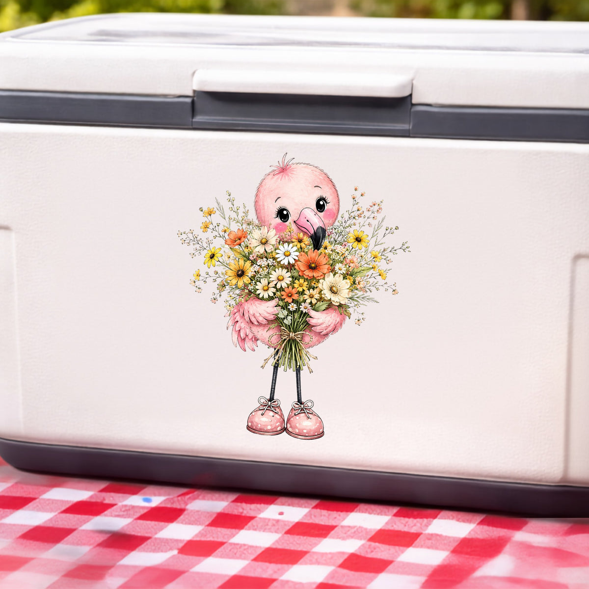 Pink Flamingo Holding Flower Bouquet UV DTF sticker applied to a white cooler on a red gingham cloth