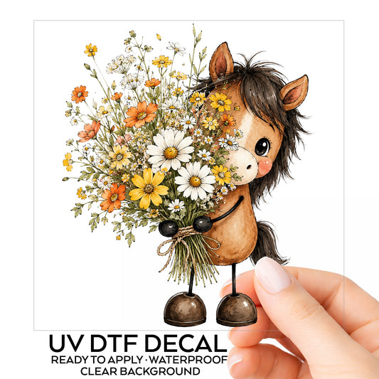 Brown Horse Holding Wildflower Bouquet UV DTF sticker on its backing card, held in hand