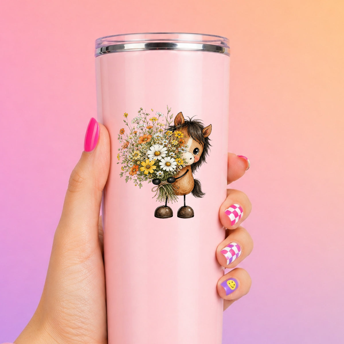 Brown Horse Holding Wildflower Bouquet UV DTF sticker applied to a tall pink tumbler on a pink and orange background