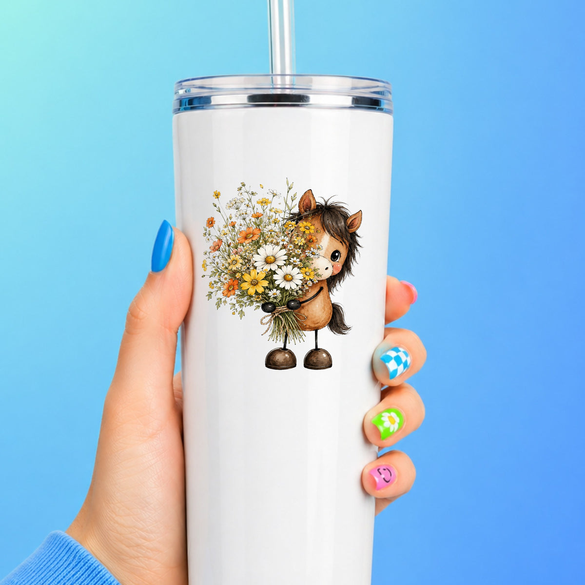 Brown Horse Holding Wildflower Bouquet UV DTF sticker applied to a white straw tumbler on a blue background