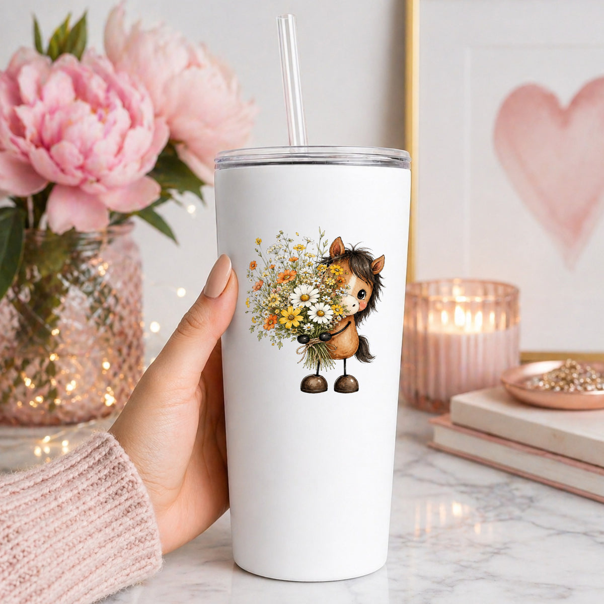 Brown Horse Holding Wildflower Bouquet UV DTF sticker applied to a white straw tumbler beside pink peonies