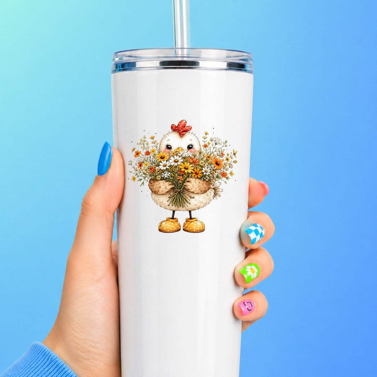 Chicken Holding Wildflower Bouquet UV DTF sticker applied to a white straw tumbler on a blue background