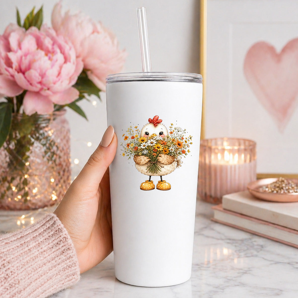 Chicken Holding Wildflower Bouquet UV DTF sticker applied to a white straw tumbler beside pink peonies