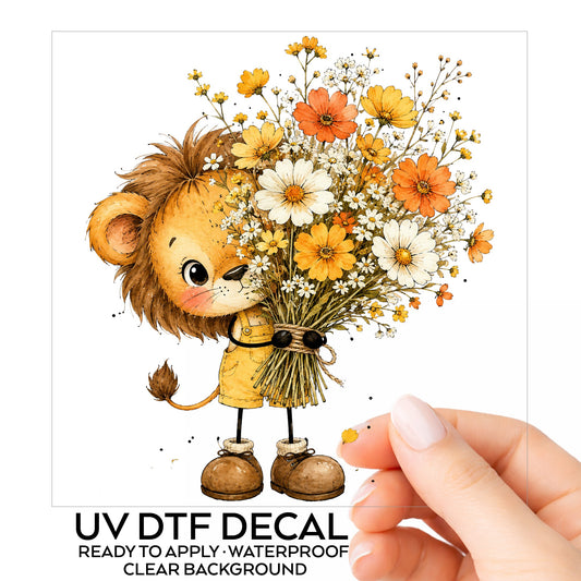 Baby Lion Holding Wildflower Bouquet UV DTF sticker on its backing card, held in hand