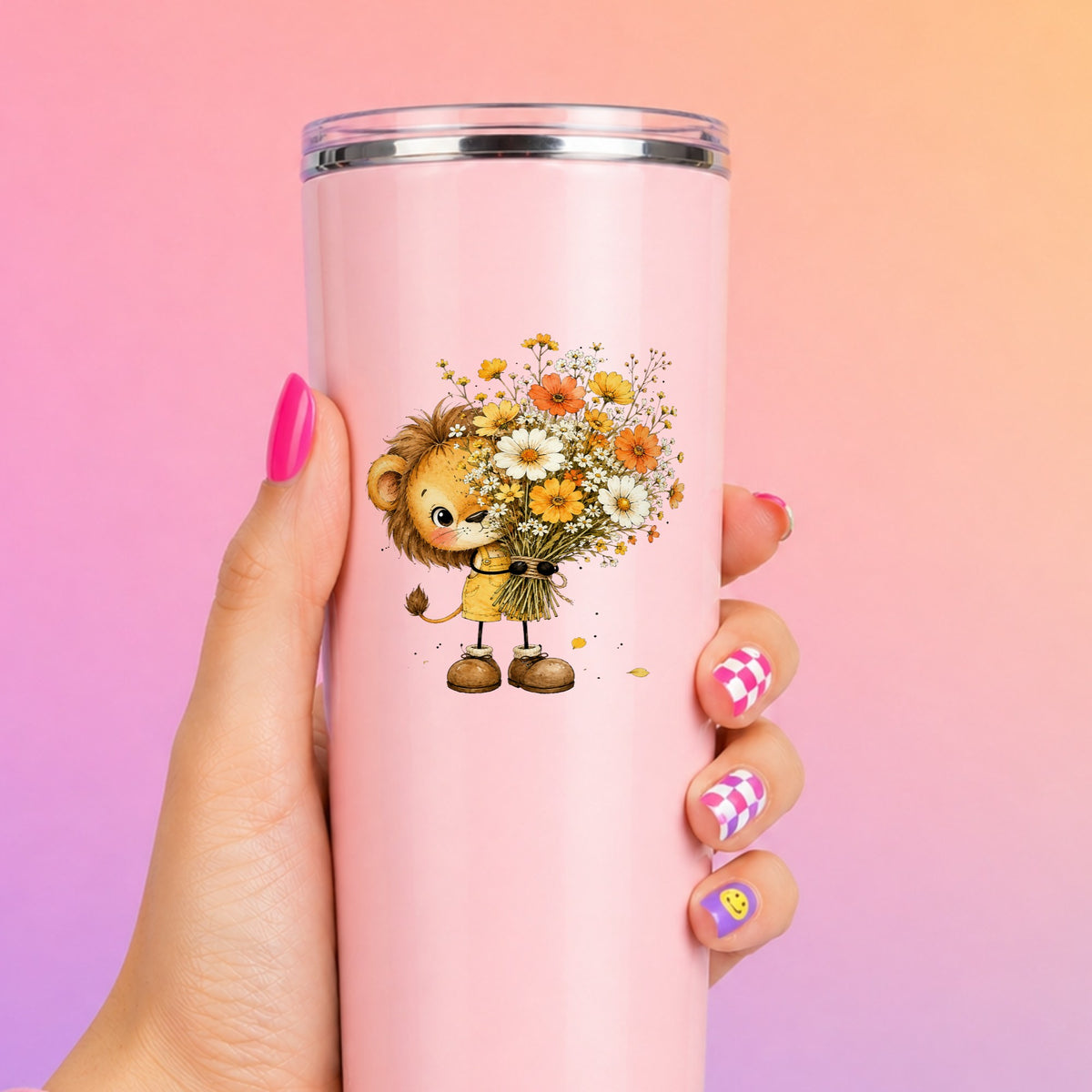 Baby Lion Holding Wildflower Bouquet UV DTF sticker applied to a tall pink tumbler on a pink and orange background