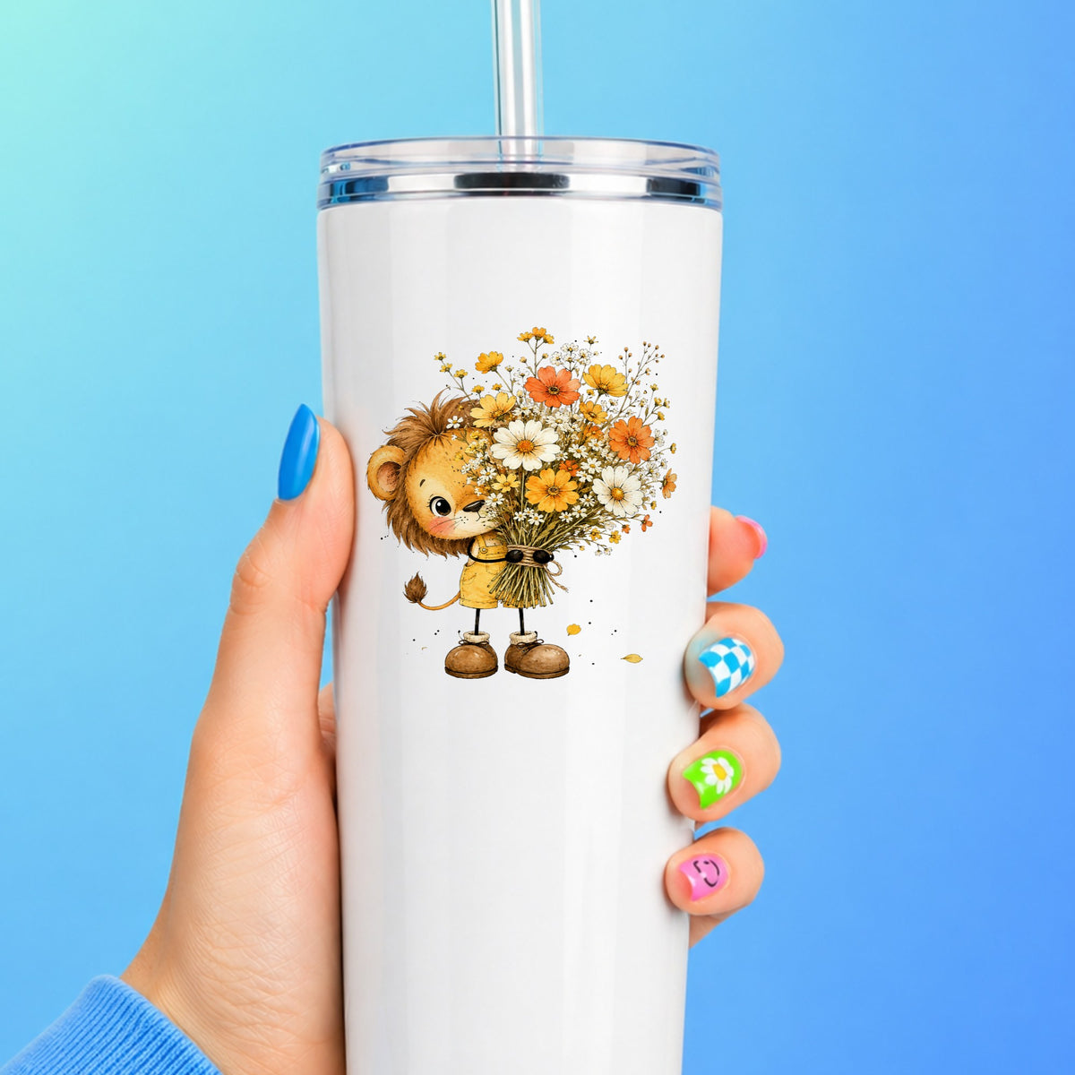 Baby Lion Holding Wildflower Bouquet UV DTF sticker applied to a white straw tumbler on a blue background