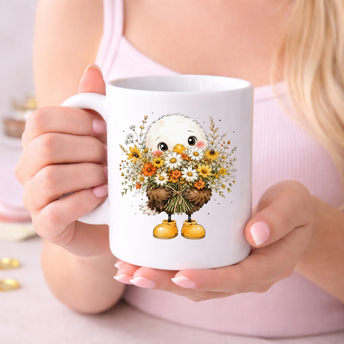 Baby Eagle Holding Daisy Bouquet UV DTF sticker applied to a white coffee mug held in both hands