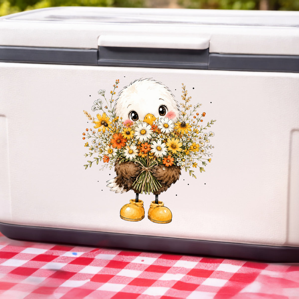 Baby Eagle Holding Daisy Bouquet UV DTF sticker applied to a white cooler on a red gingham cloth