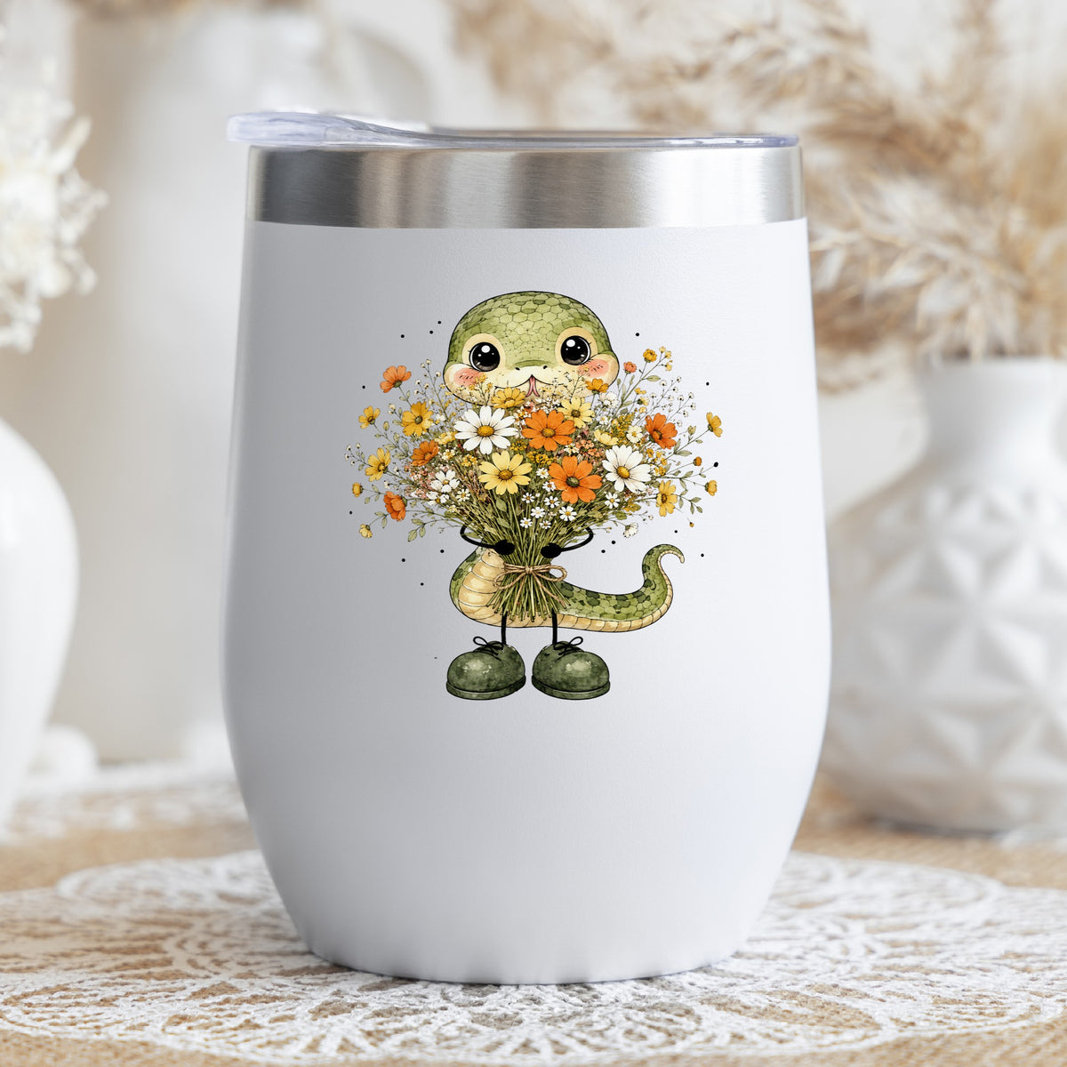 Green Snake Holding Wildflower Bouquet UV DTF sticker applied to a white stemless tumbler with a lid