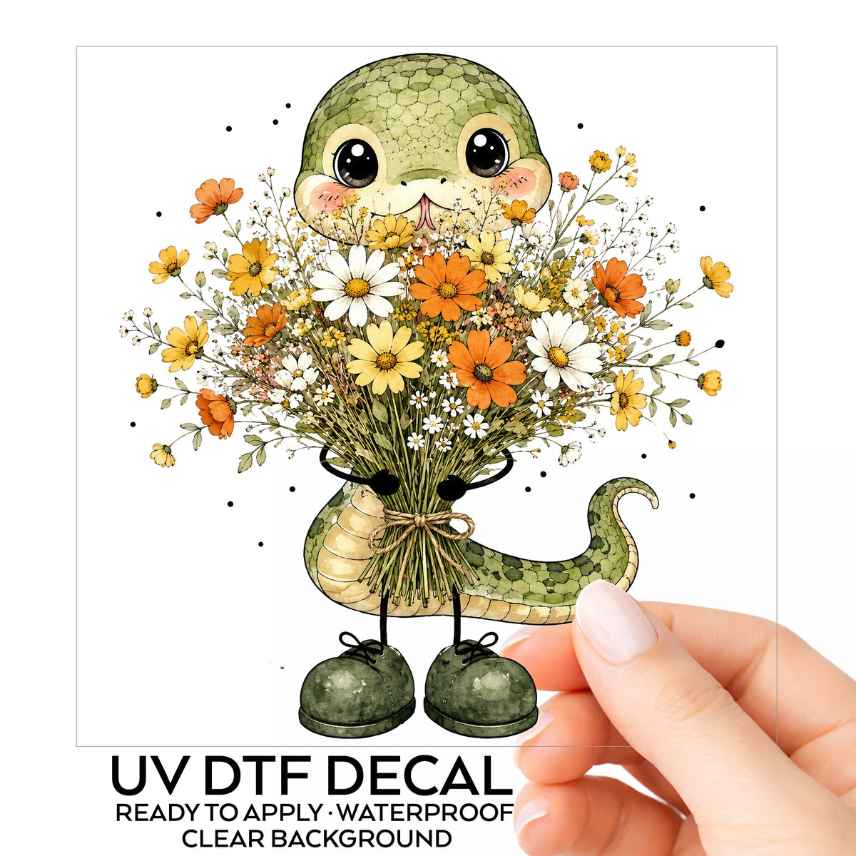 Green Snake Holding Wildflower Bouquet UV DTF sticker on its backing card, held in hand