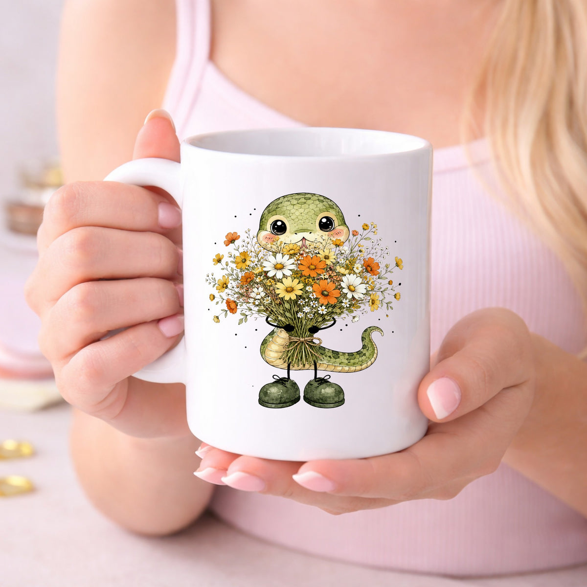 Green Snake Holding Wildflower Bouquet UV DTF sticker applied to a white coffee mug held in both hands