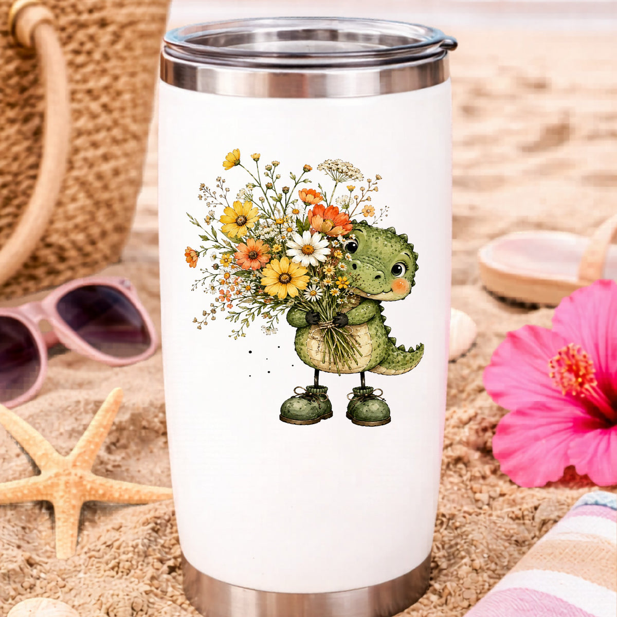 Baby Crocodile Holding Flower Bouquet UV DTF sticker applied to a white travel tumbler on beach sand