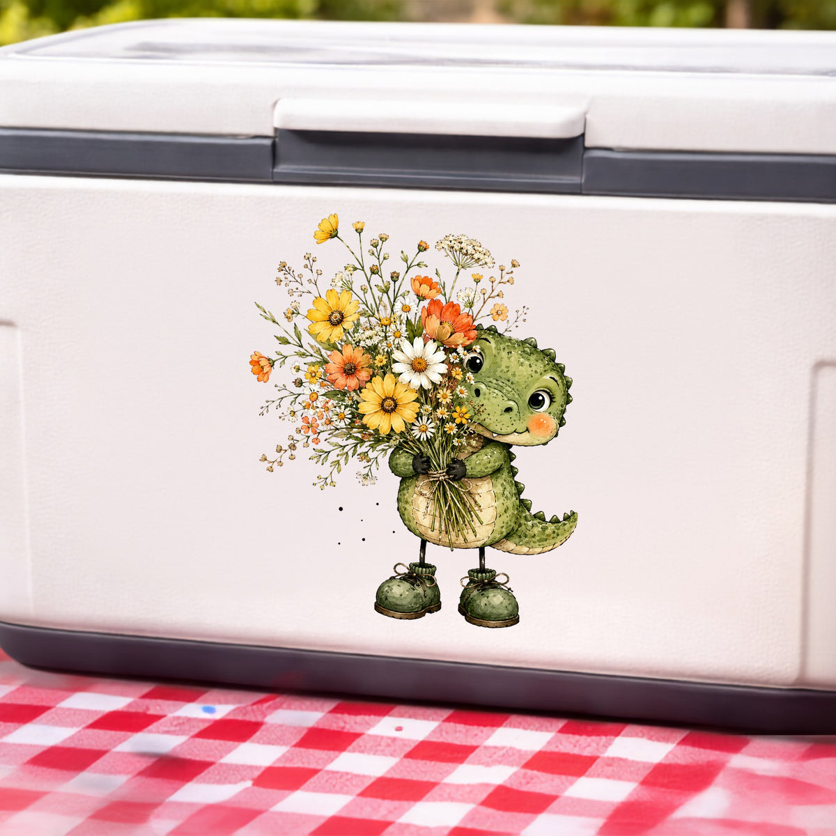 Baby Crocodile Holding Flower Bouquet UV DTF sticker applied to a white cooler on a red gingham cloth