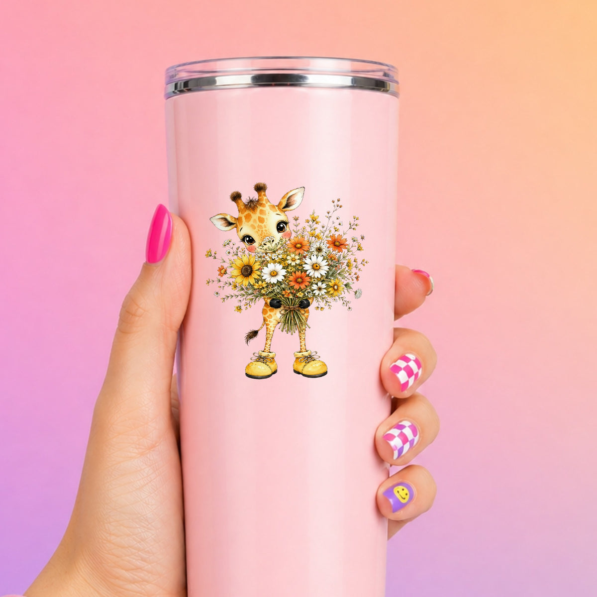 Giraffe Holding Sunflower Bouquet UV DTF sticker applied to a tall pink tumbler on a pink and orange background