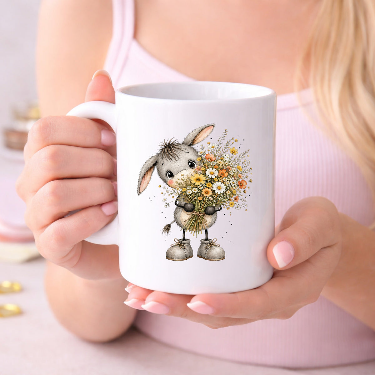 Baby Donkey Holding Wildflower Bouquet UV DTF sticker applied to a white coffee mug held in both hands