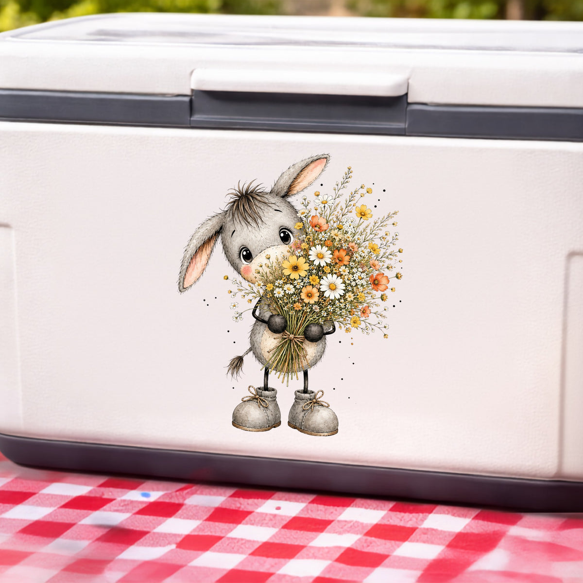 Baby Donkey Holding Wildflower Bouquet UV DTF sticker applied to a white cooler on a red gingham cloth
