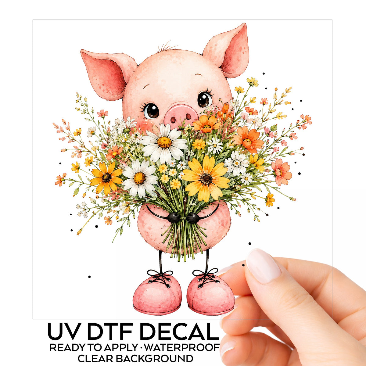 Pink Pig Holding Wildflower Bouquet UV DTF sticker on its backing card, held in hand
