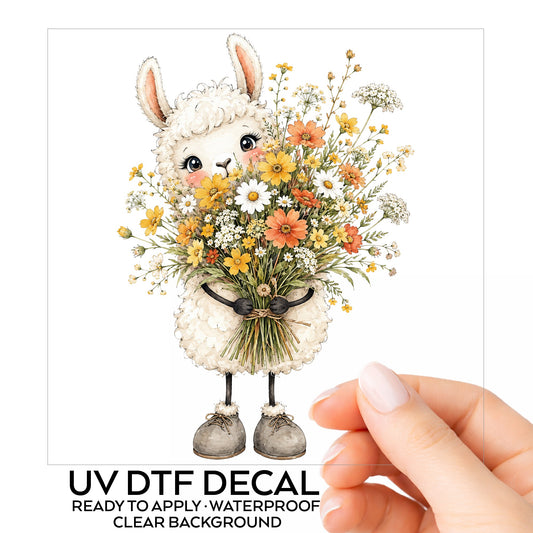 White Llama Holding Daisy Bouquet UV DTF sticker on its backing card, held in hand