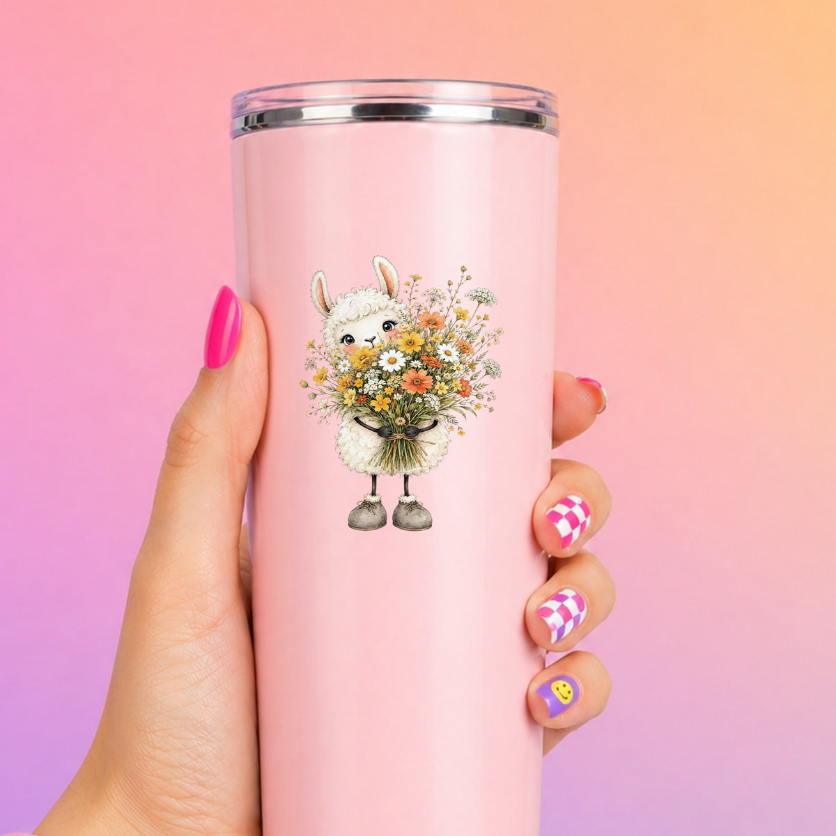 White Llama Holding Daisy Bouquet UV DTF sticker applied to a tall pink tumbler on a pink and orange background