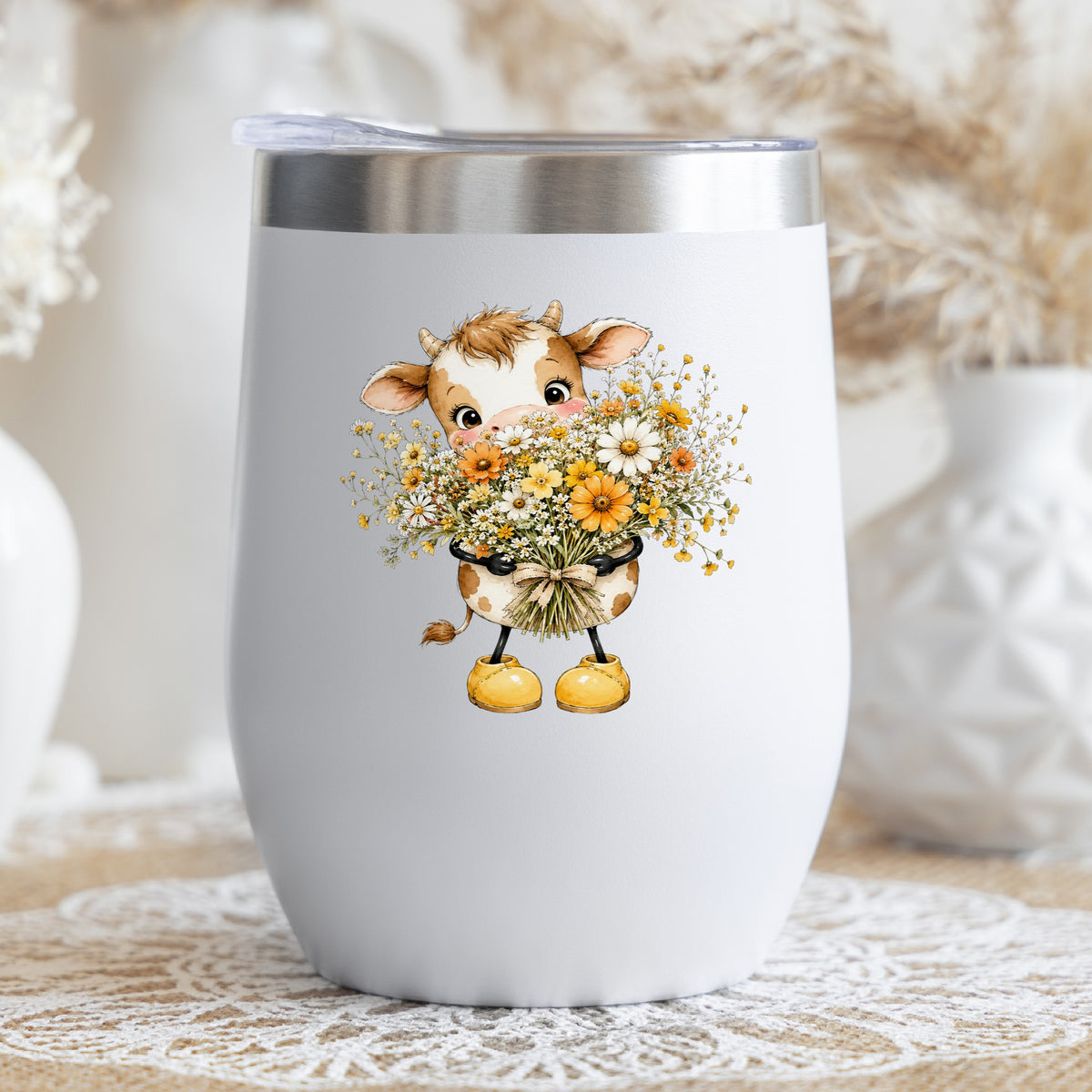 Baby Cow Holding Wildflower Bouquet UV DTF sticker applied to a white stemless tumbler with a lid