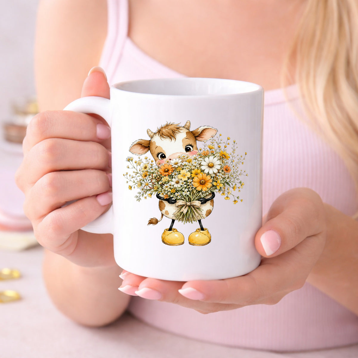 Baby Cow Holding Wildflower Bouquet UV DTF sticker applied to a white coffee mug held in both hands