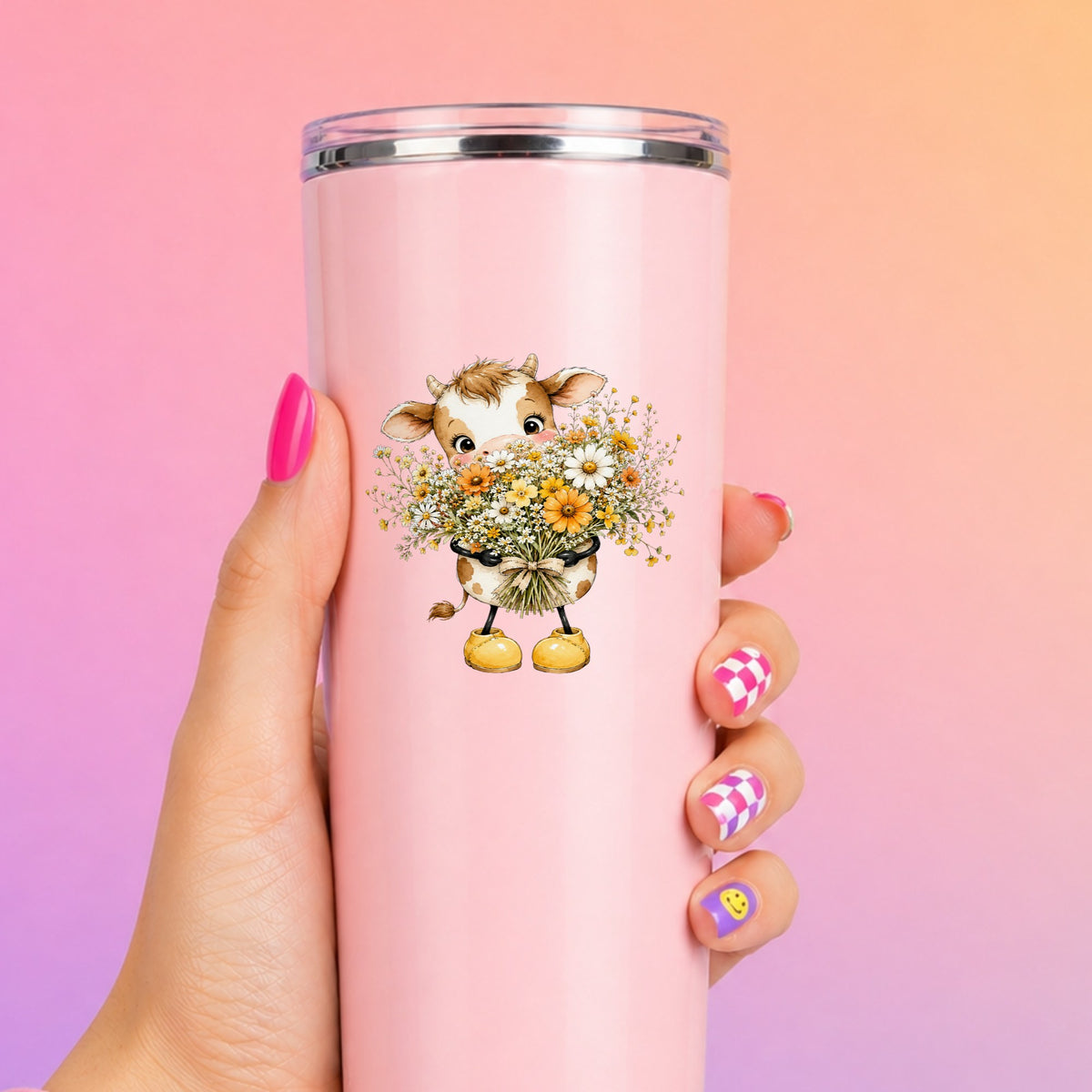 Baby Cow Holding Wildflower Bouquet UV DTF sticker applied to a tall pink tumbler on a pink and orange background